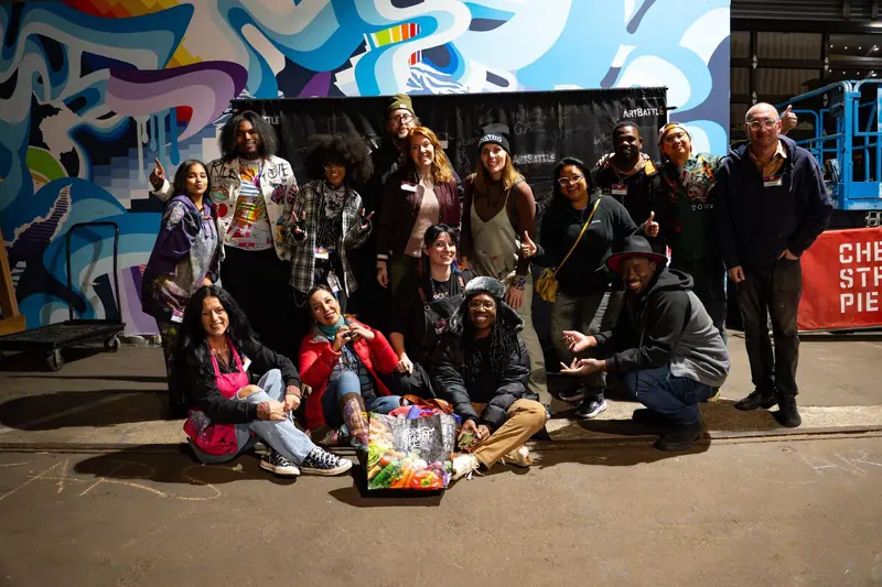 Founders, artists and organizers in front of a mural wall at Cherry Street Pier